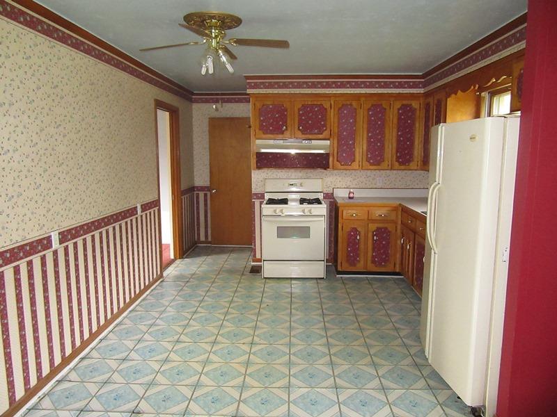 506 Wren Road Clarksville, TN 37040 - Photo 3 of 8 a kitchen with stainless steel appliances granite countertop a refrigerator a stove and a sink with wooden floor