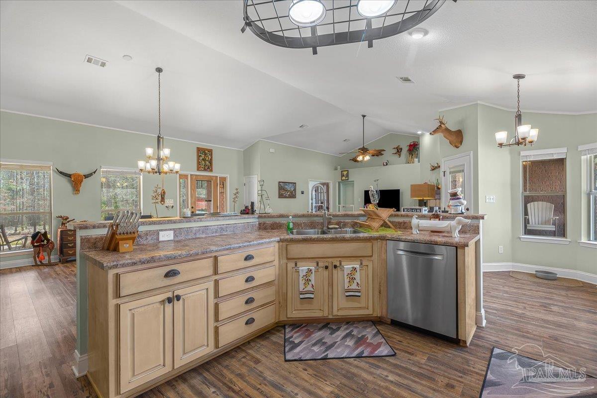 1766 Narrow Road Jay, FL 32565 - Photo 16 of 55 a large kitchen with kitchen island a stove a sink dishwasher a dining table and chairs with wooden floor