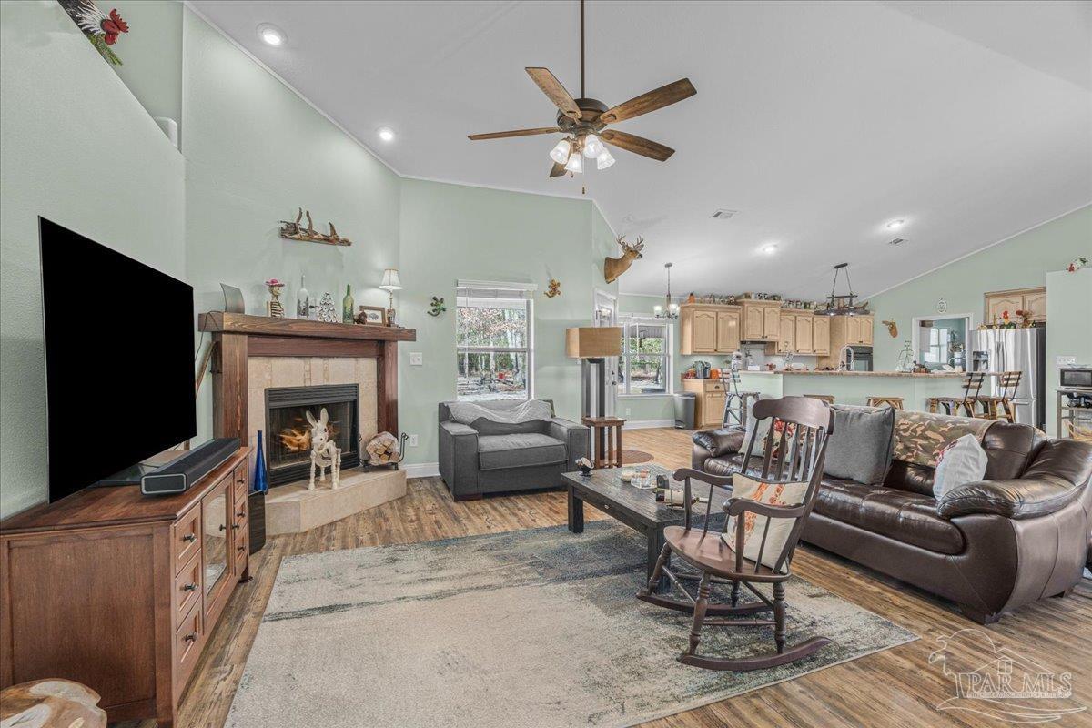 1766 Narrow Road Jay, FL 32565 - Photo 26 of 55 a living room with furniture a flat screen tv and a fireplace