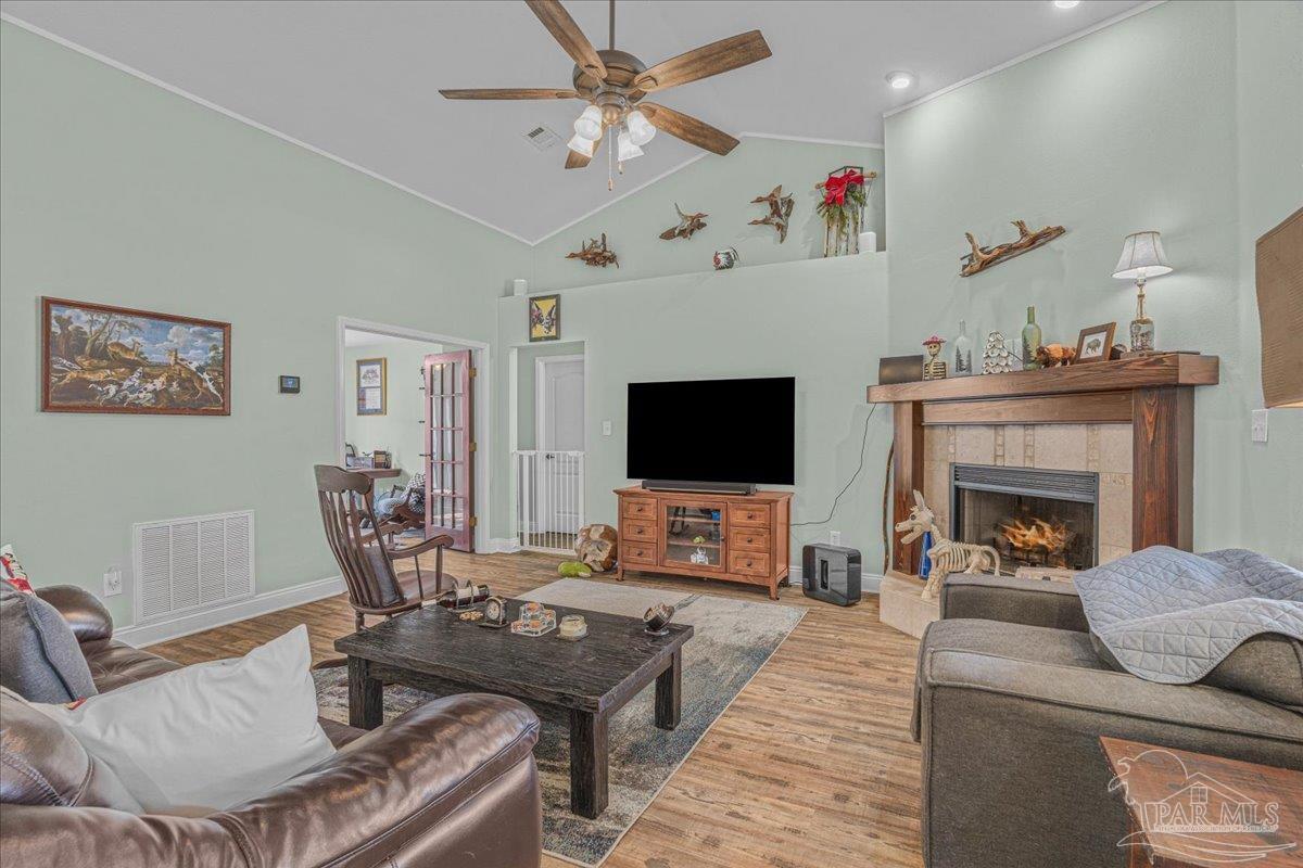 1766 Narrow Road Jay, FL 32565 - Photo 27 of 55 a living room with furniture a flat screen tv and a fireplace
