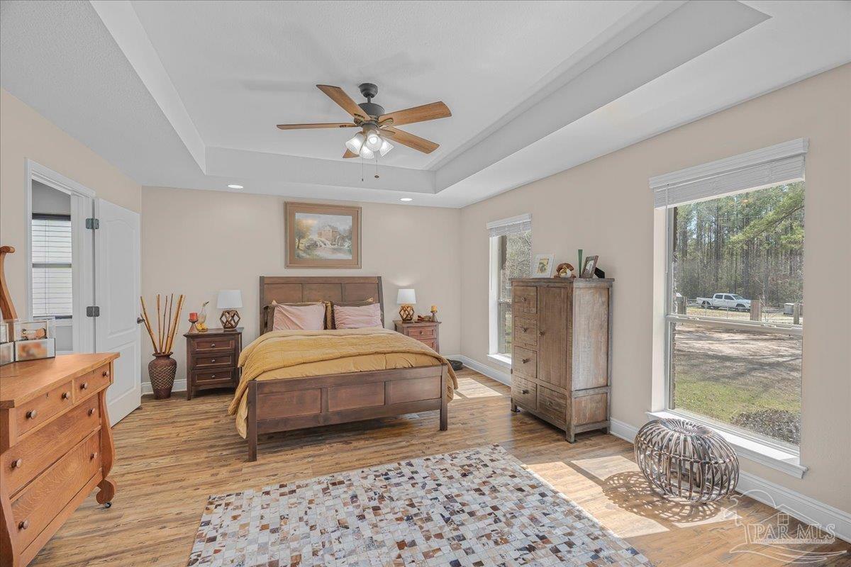 1766 Narrow Road Jay, FL 32565 - Photo 30 of 55 a bedroom with a bed dresser and wooden floor