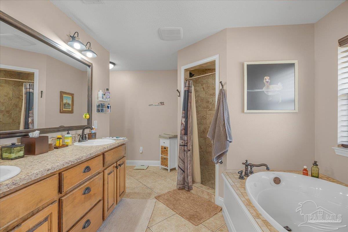 1766 Narrow Road Jay, FL 32565 - Photo 33 of 55 a spacious bathroom with a tub sink and mirror