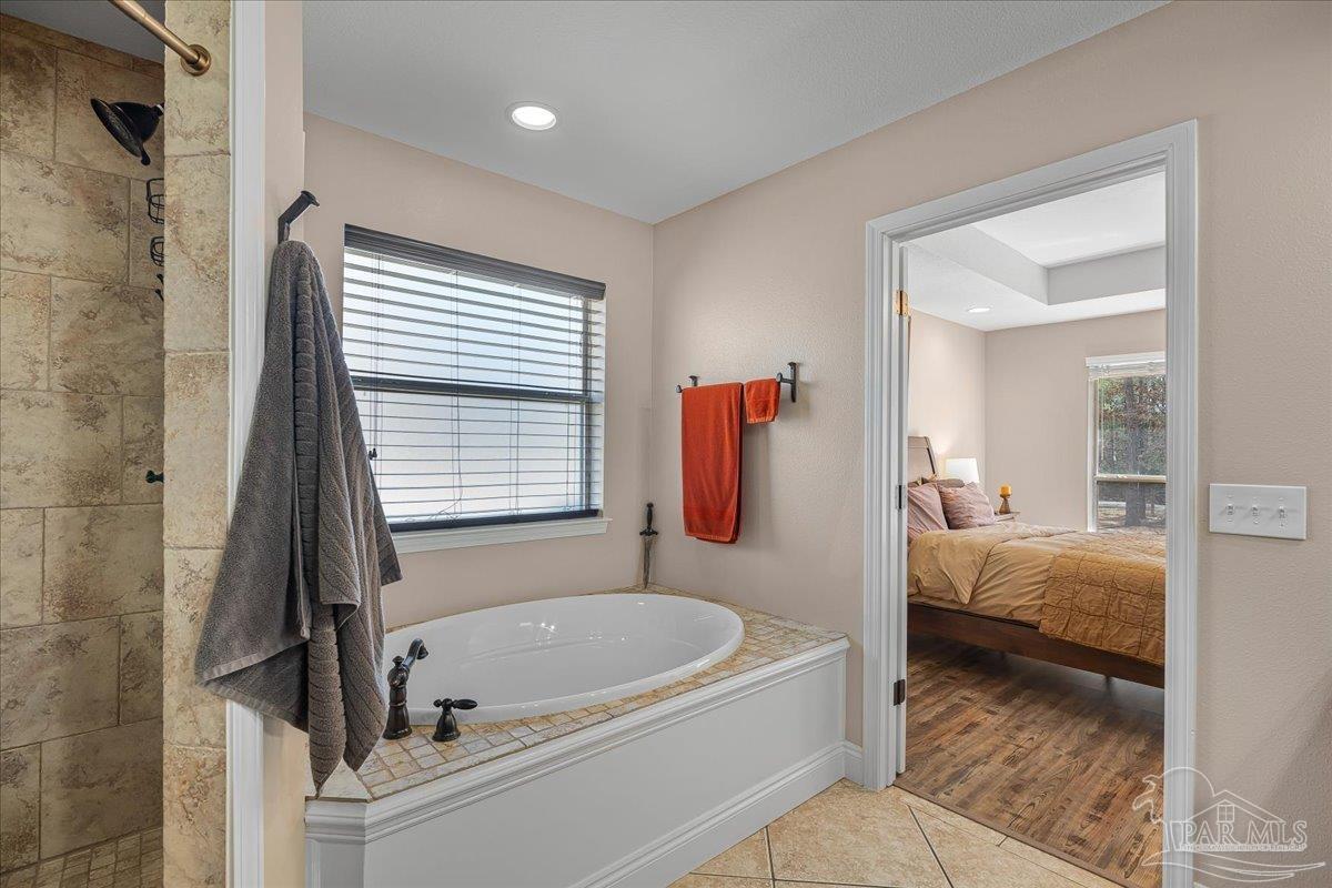 1766 Narrow Road Jay, FL 32565 - Photo 34 of 55 a bathroom with a tub and a shower