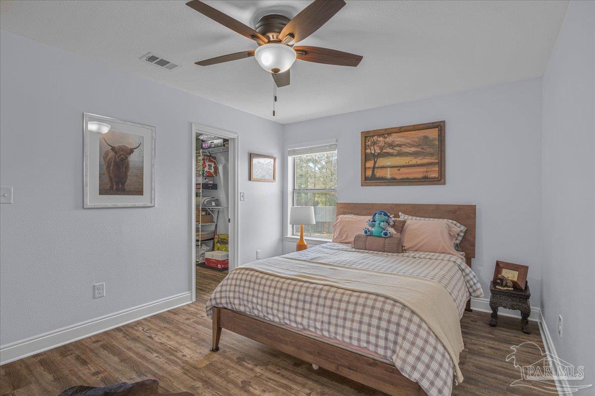 1766 Narrow Road Jay, FL 32565 - Photo 39 of 55 a bedroom with a bed painting on the wall and a window