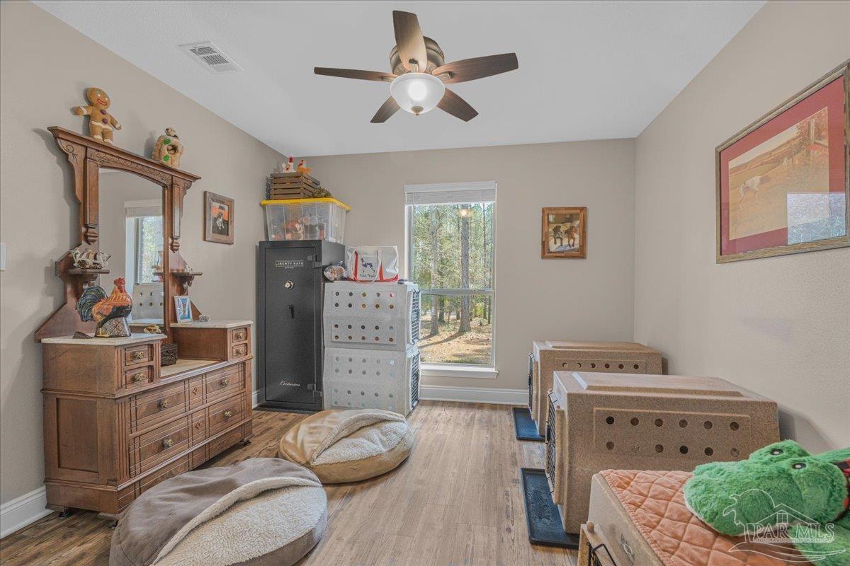 1766 Narrow Road Jay, FL 32565 - Photo 41 of 55 a bedroom with furniture and a wooden floor