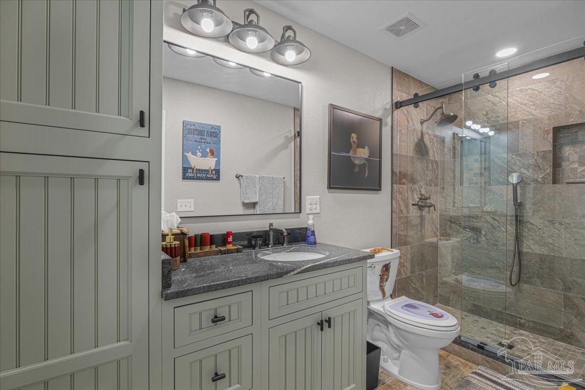 1766 Narrow Road Jay, FL 32565 - Photo 43 of 55 a bathroom with a granite countertop sink a toilet a mirror and shower