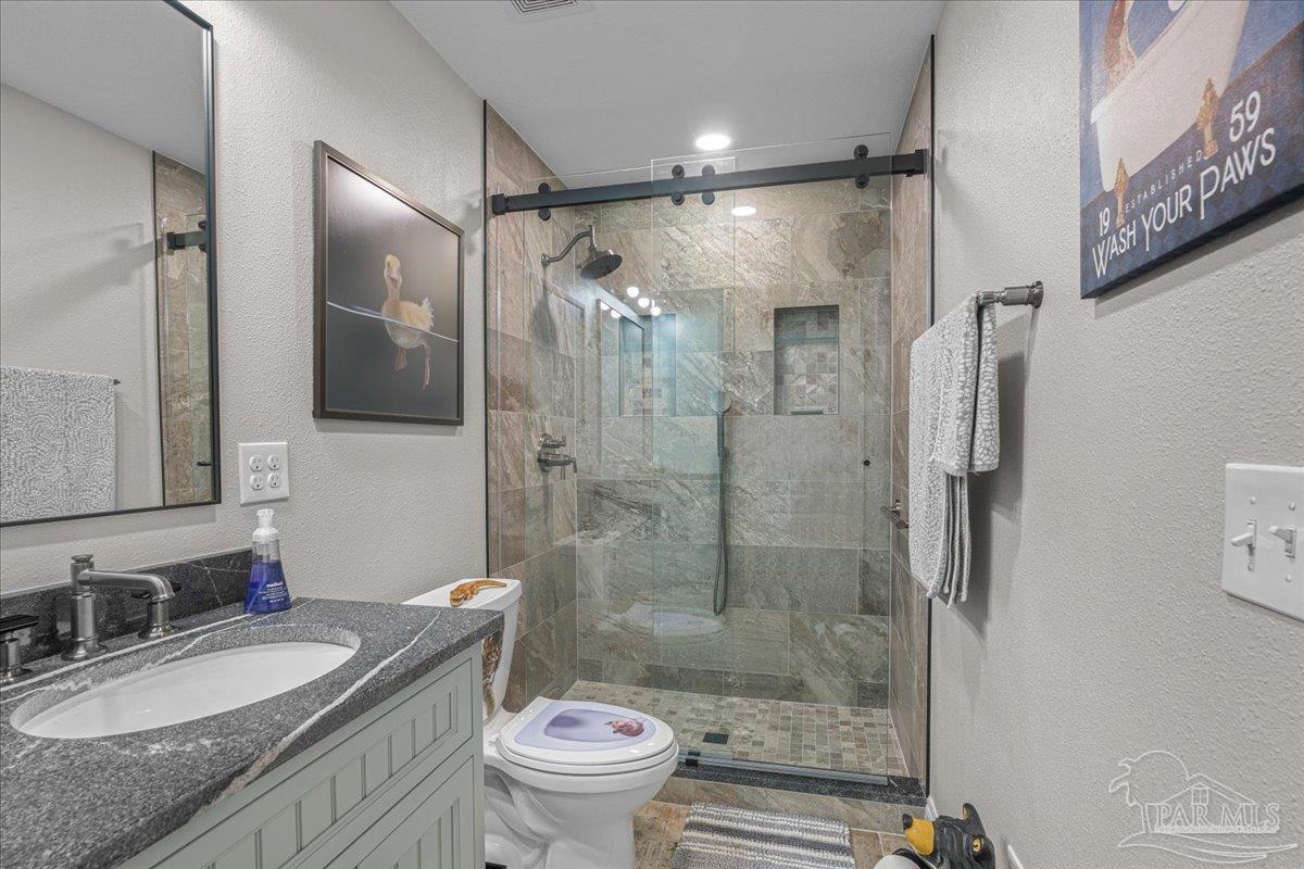 1766 Narrow Road Jay, FL 32565 - Photo 44 of 55 a bathroom with a granite countertop sink toilet and shower