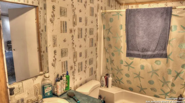 a bathroom with a bathtub and shower curtain