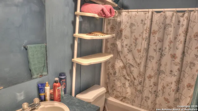 a bathroom with a toilet and a sink