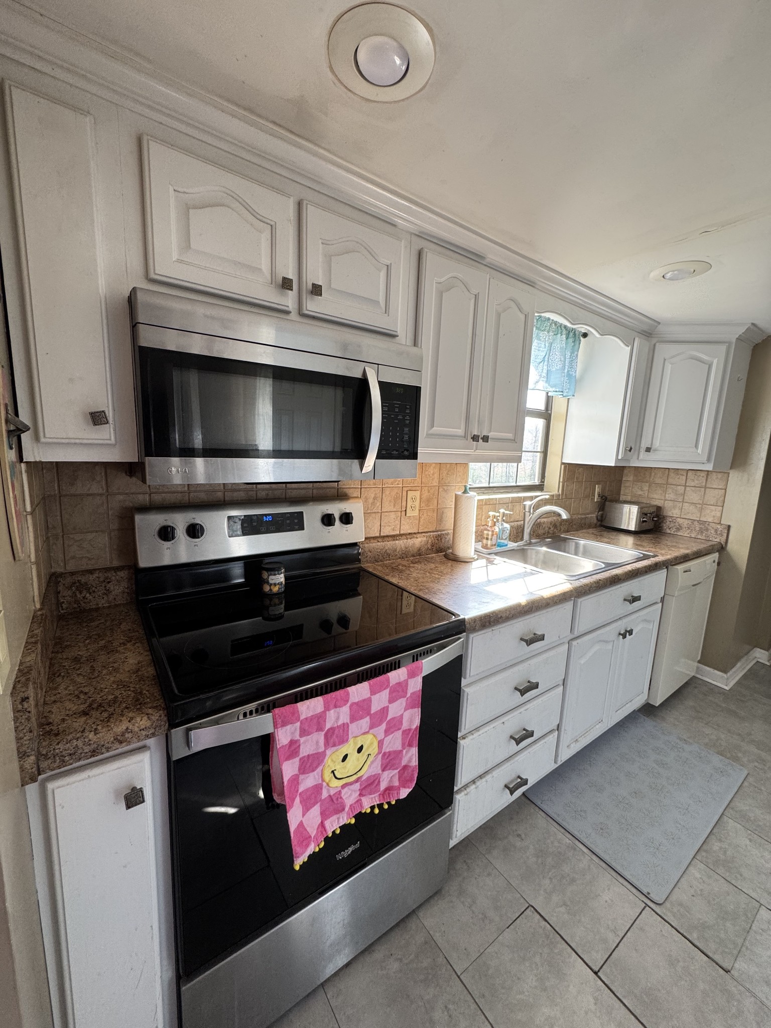 57 East Crystal Springs Road Kelso, TN 37348 - Photo 19 of 28 a kitchen with granite countertop a stove microwave and cabinets