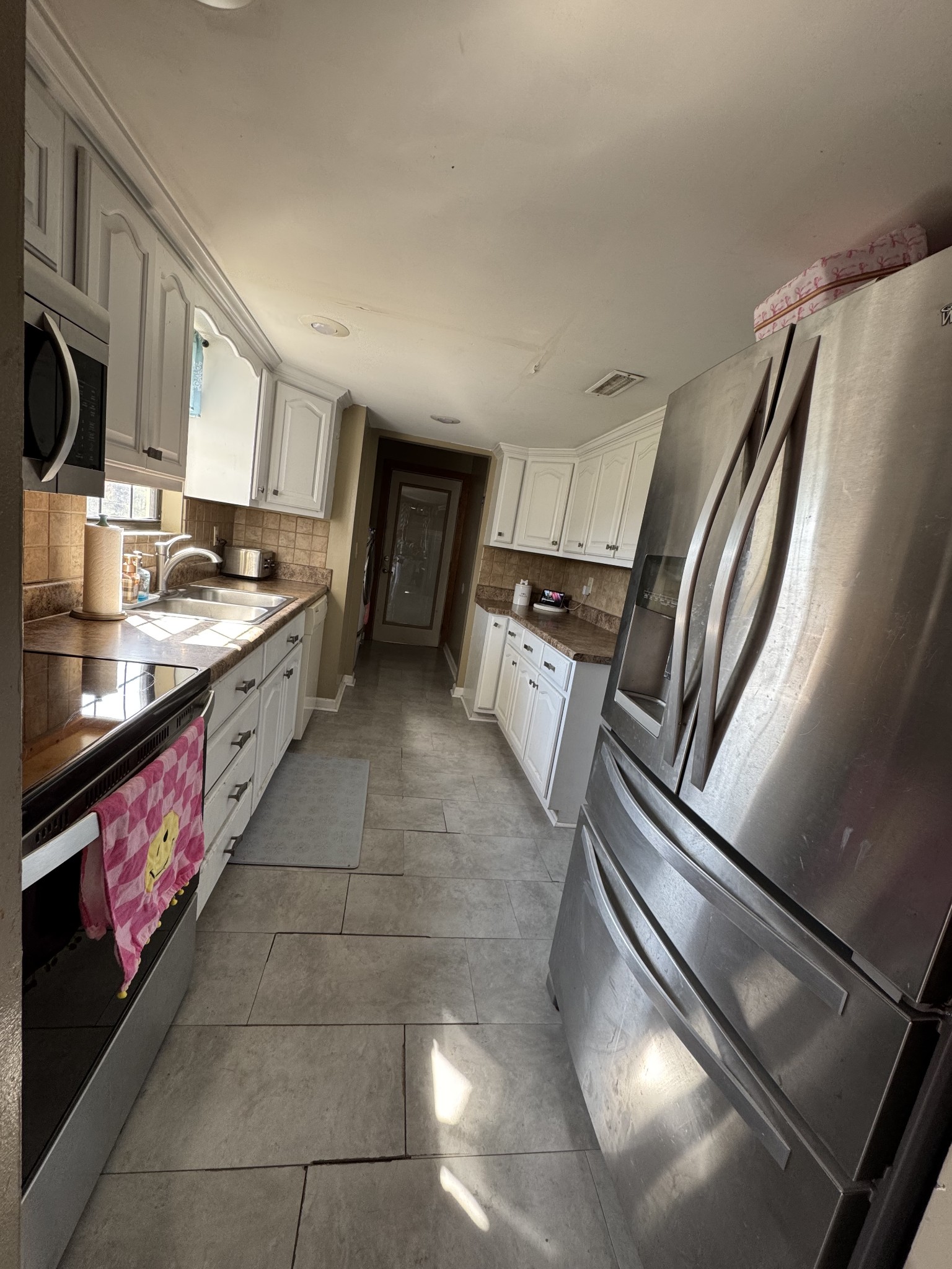 57 East Crystal Springs Road Kelso, TN 37348 - Photo 21 of 28 a kitchen with stainless steel appliances a sink stove and cabinets