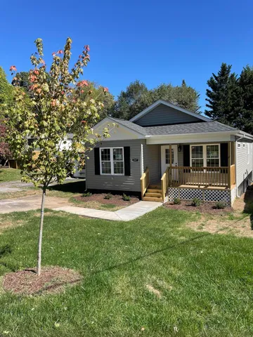 a front view of a house with a yard table and chairs