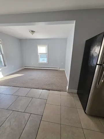 a view of a livingroom with an empty space and a sink