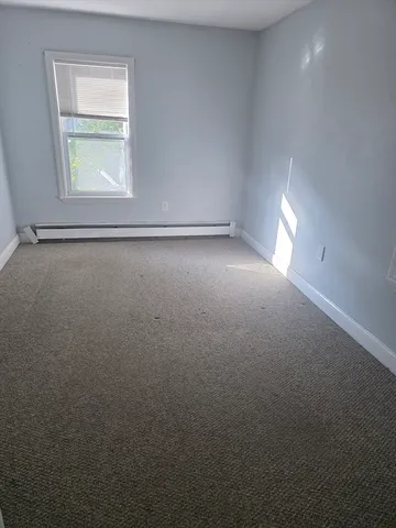 an empty room that has a window in it