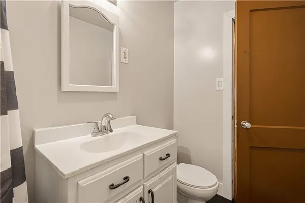 a bathroom with a sink toilet and a mirror