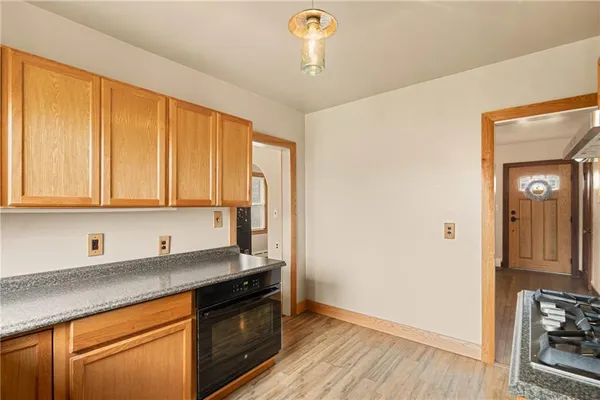 a kitchen with granite countertop cabinets stainless steel appliances and a counter space