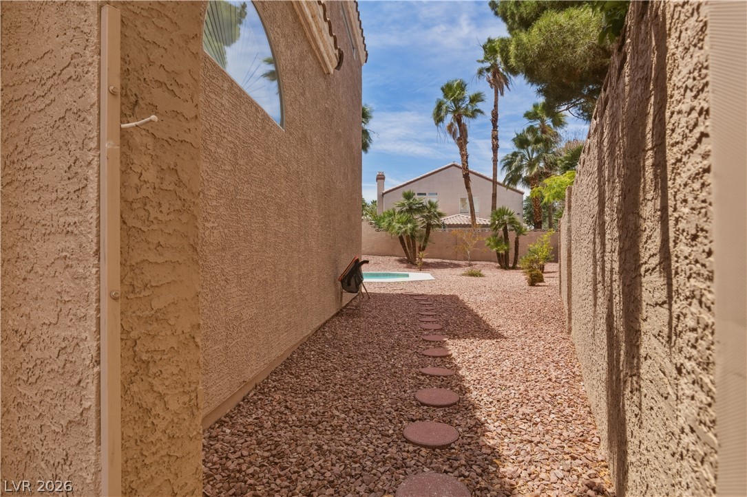 29 Olive Tree Henderson, NV 89074 - Photo 51 of 60 This outdoor space offers a private retreat with a tranquil pool, mature palm trees, and clear blue skies.