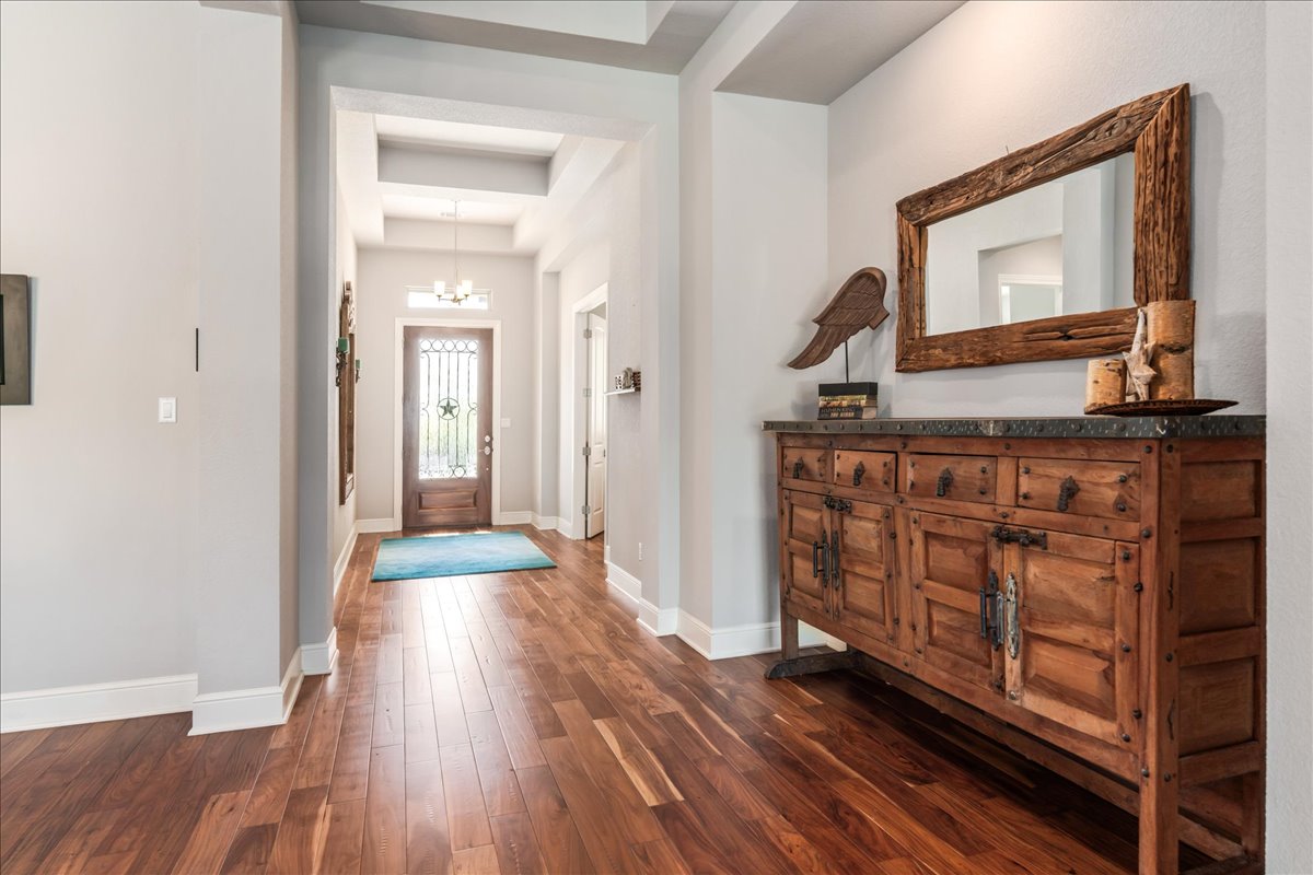 413 Montalcino Lane Georgetown, TX 78628 - Photo 11 of 40 a view of a hallway with wooden floor