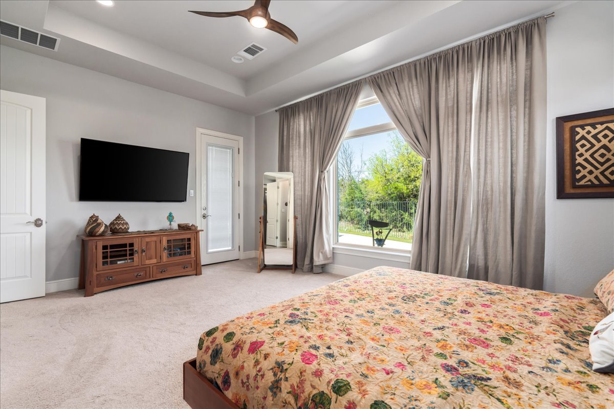 413 Montalcino Lane Georgetown, TX 78628 - Photo 22 of 40 a bedroom with a bed and a flat screen tv