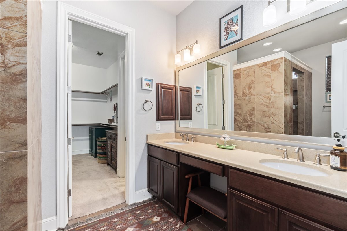 413 Montalcino Lane Georgetown, TX 78628 - Photo 23 of 40 a bathroom with a sink double vanity and a mirror