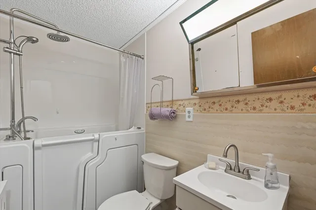 a bedroom with a bed and a potted plant next to a window