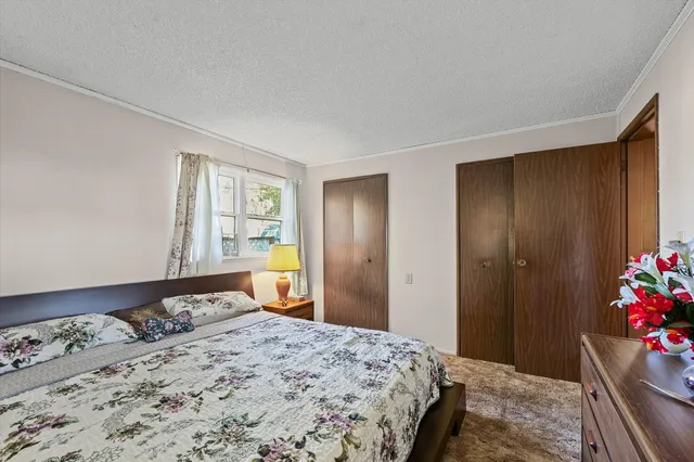 a bedroom with a bed and a dresser in it