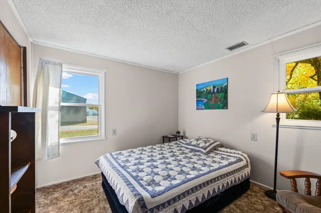 a bed room with a bed and a chair