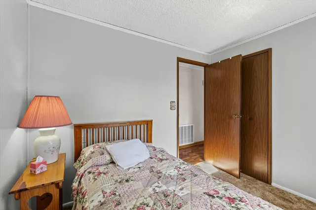 a view of a house with backyard and trees