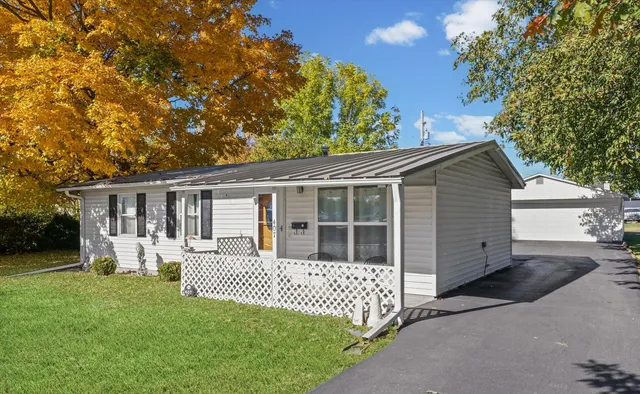 a front view of a house with a garden