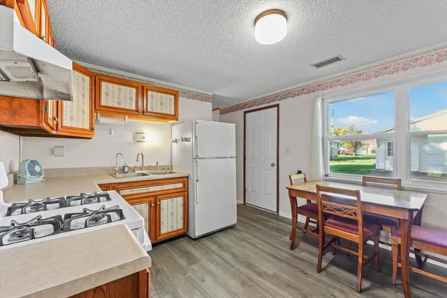 a kitchen with stainless steel appliances granite countertop a stove and a refrigerator