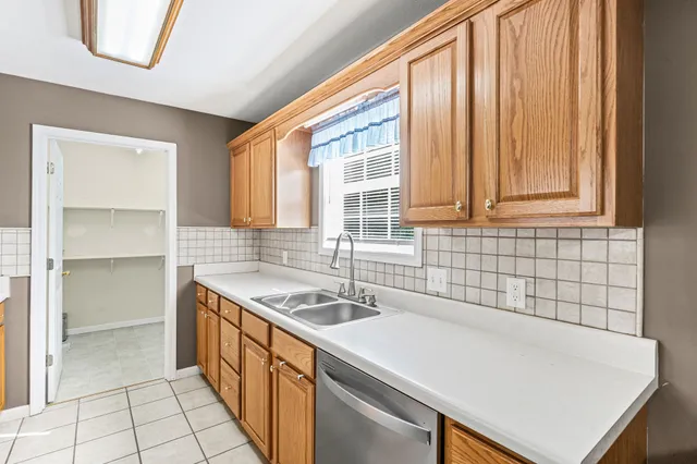 a kitchen that has a sink and a stove in it