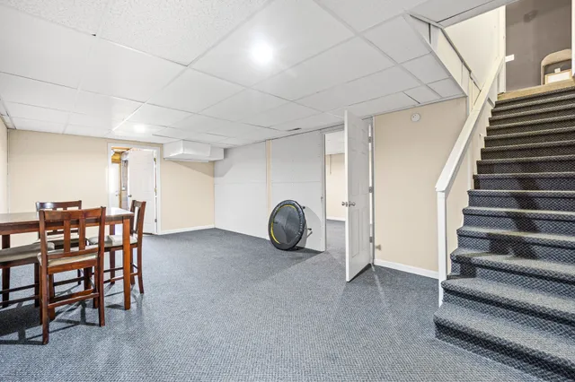 a view of a livingroom with furniture and staircase
