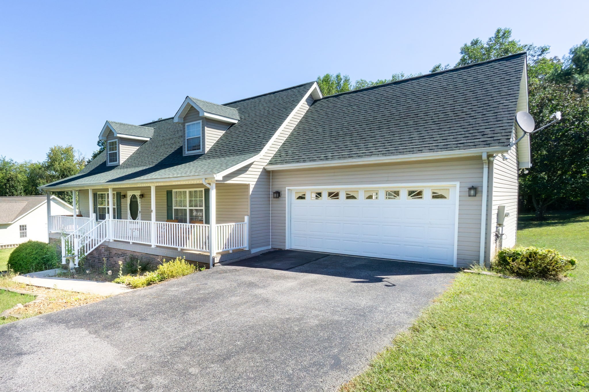 291 Poplar Point Lane Rickman, TN 38580 - Photo 2 of 34 a front view of a house with a yard and garage
