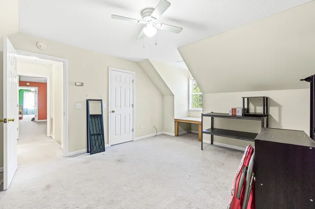 a view of a livingroom with furniture and a ceiling fan