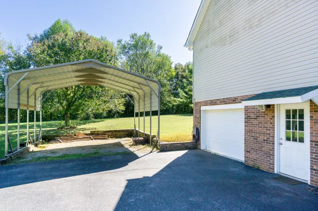 a view of a house with backyard and sitting area