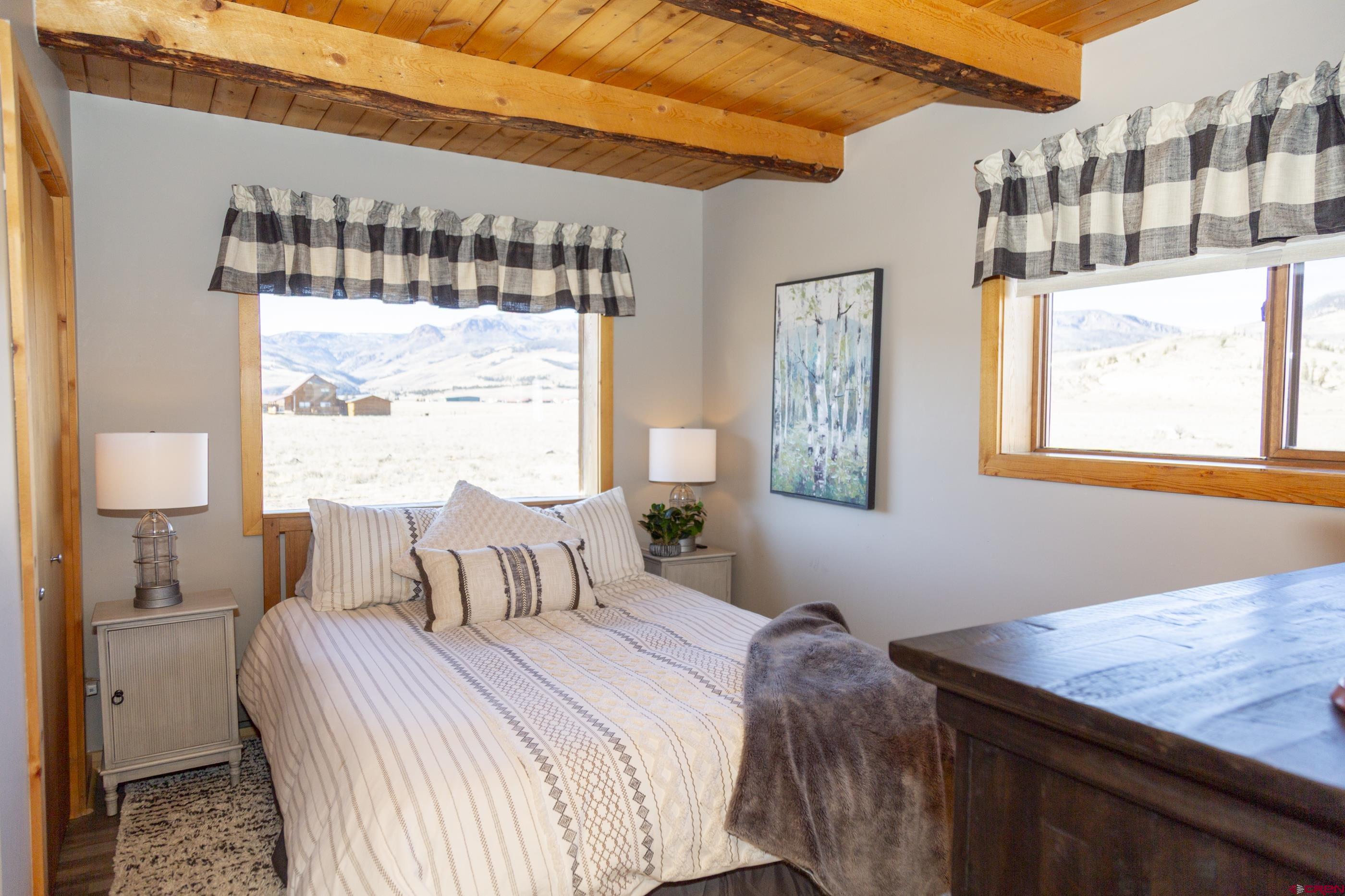 415 Ridge Drive Creede, CO 81130 - Photo 11 of 28 a bedroom with a bed and a window