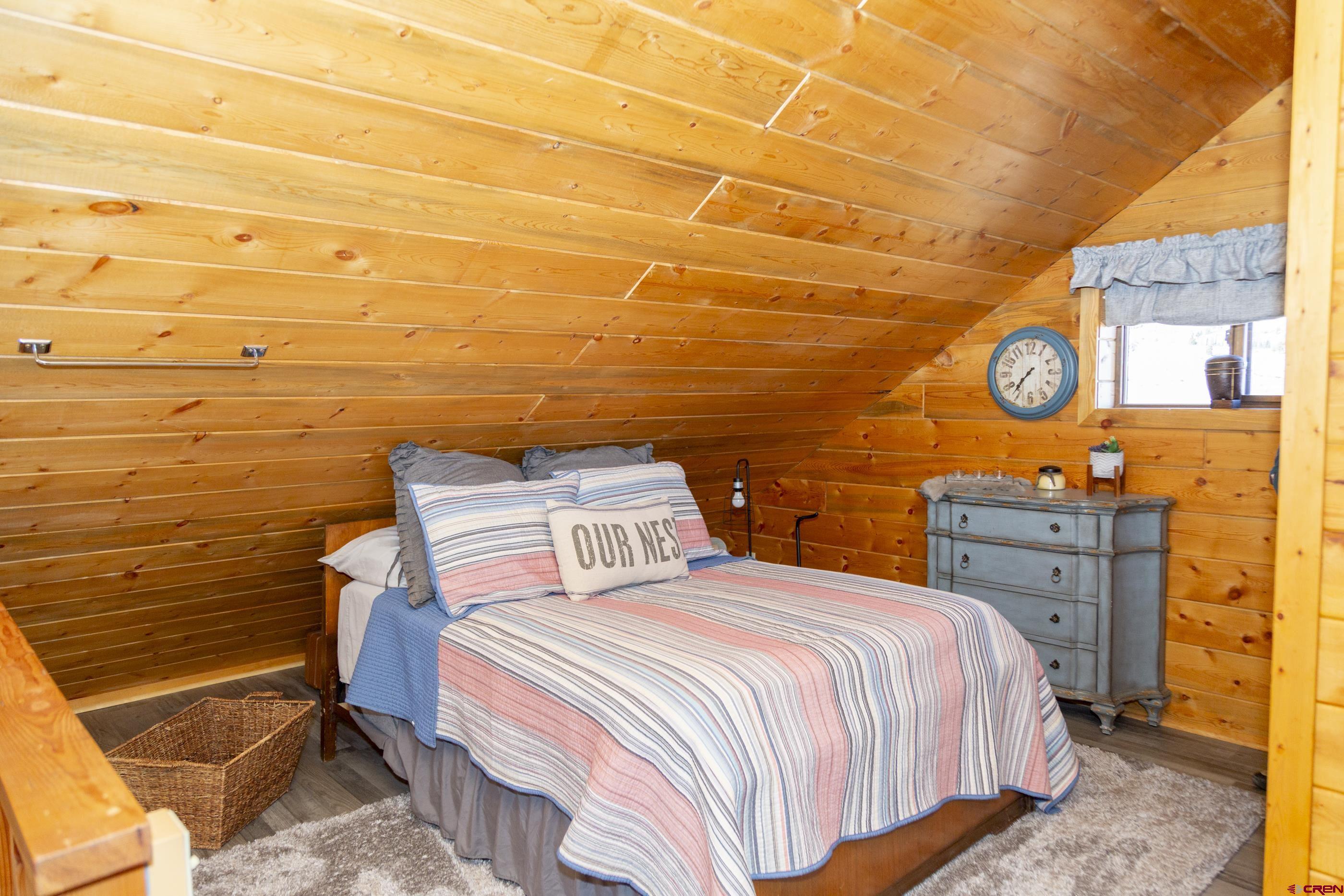 415 Ridge Drive Creede, CO 81130 - Photo 13 of 28 a bedroom with a bed and cabinets