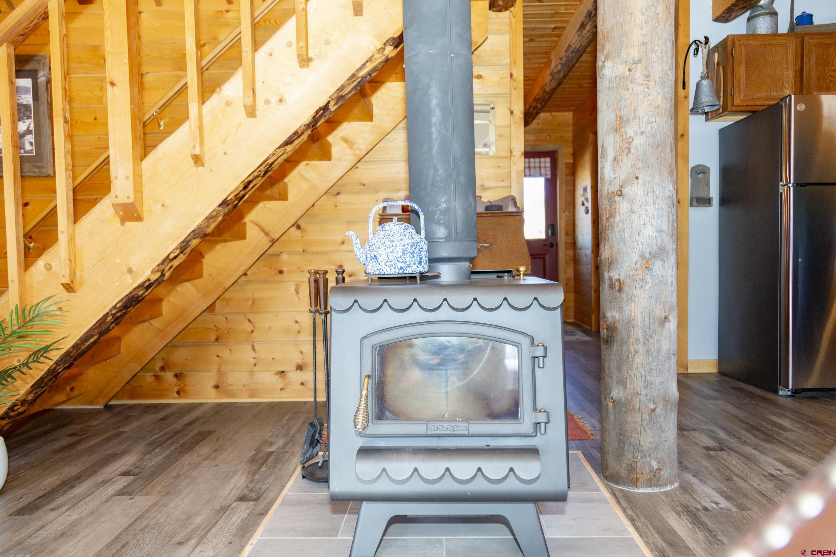 415 Ridge Drive Creede, CO 81130 - Photo 17 of 28 a living room with a fireplace furniture a rug and a window