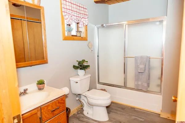 a bathroom with a granite countertop toilet sink and mirror