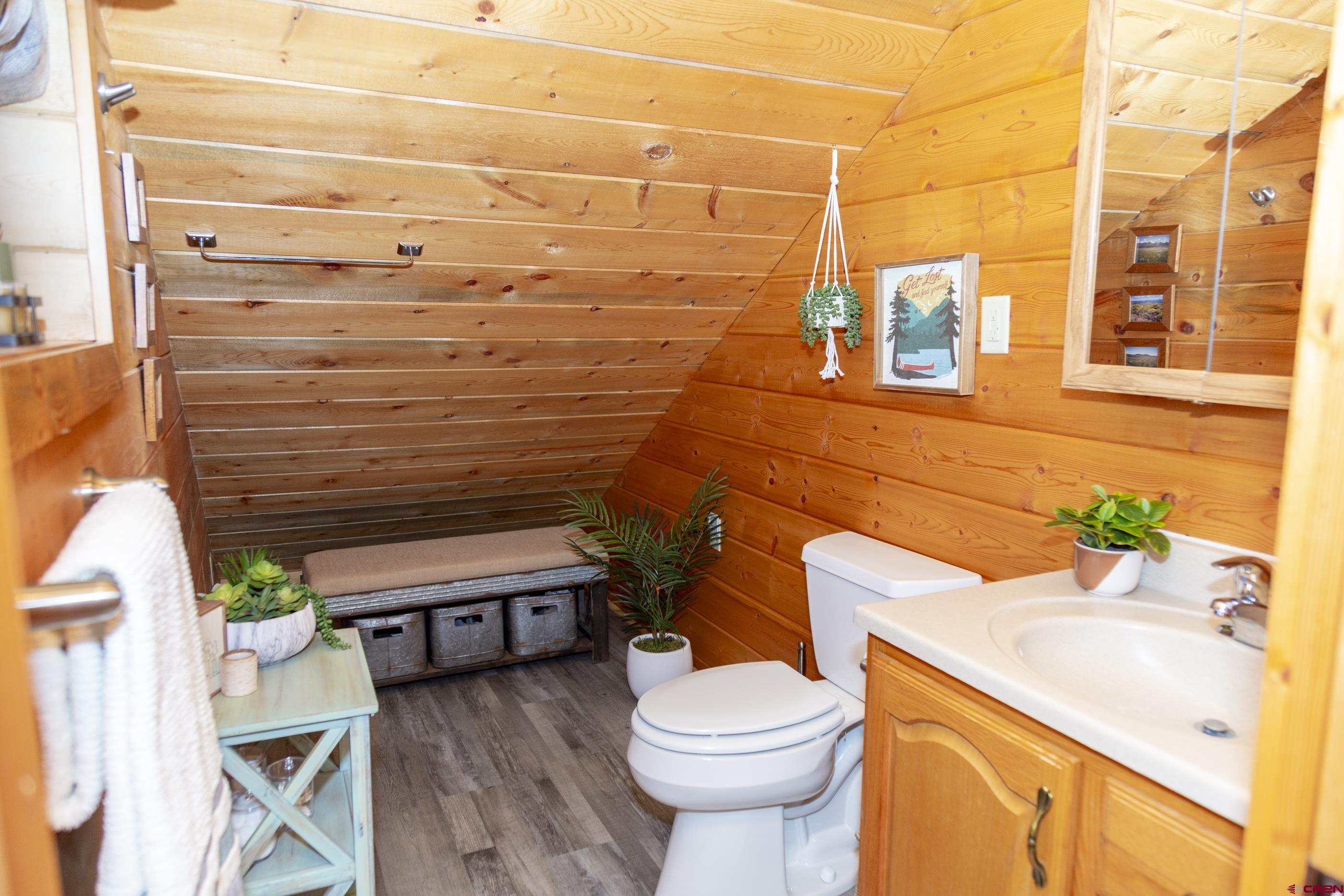 415 Ridge Drive Creede, CO 81130 - Photo 19 of 28 a bathroom with a granite countertop toilet sink and mirror