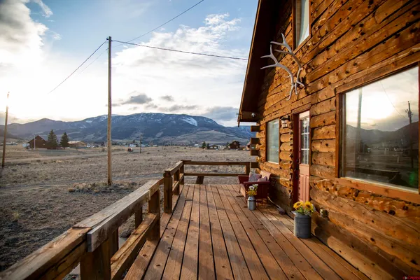a view of balcony with wooden floor and outdoor seating