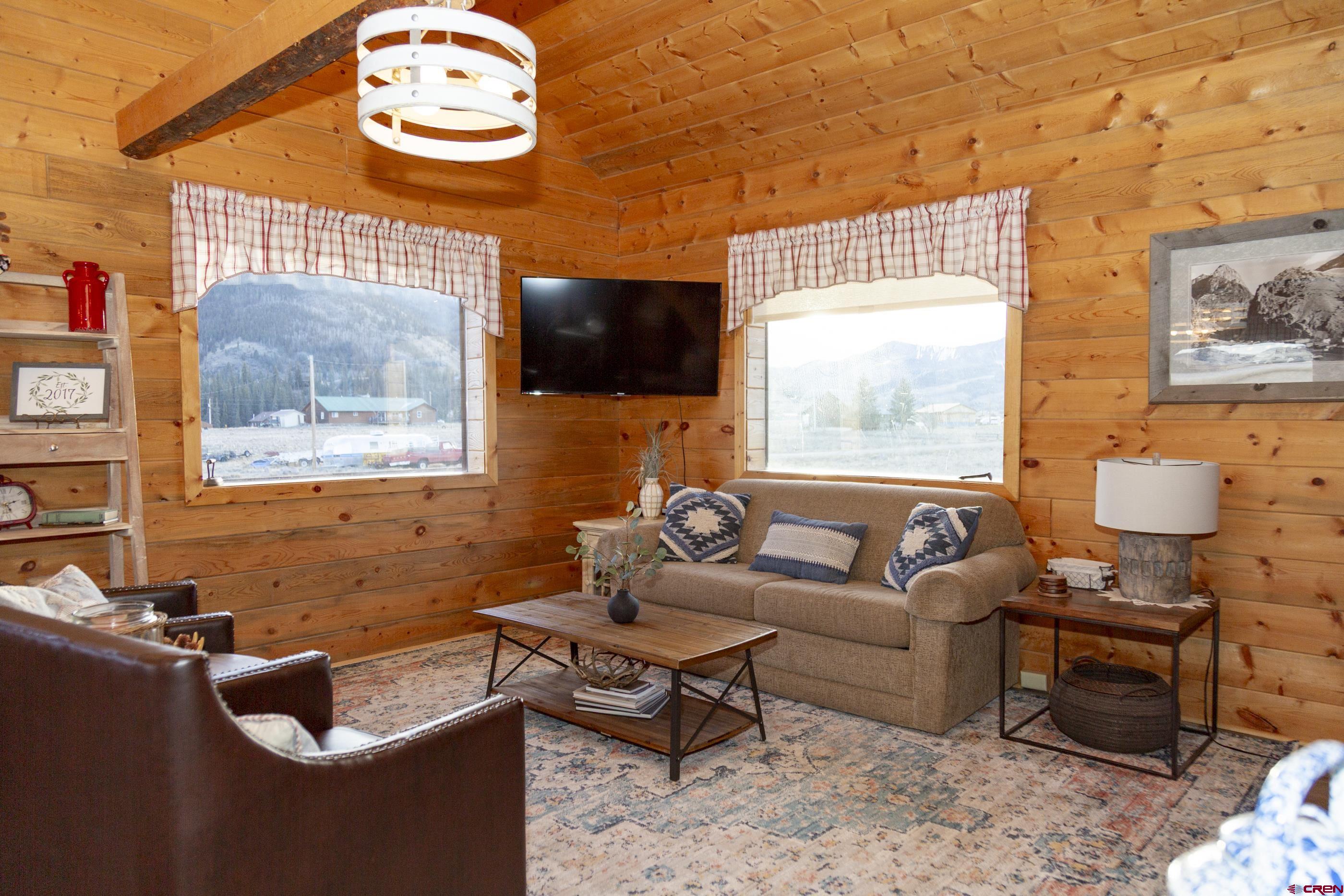 415 Ridge Drive Creede, CO 81130 - Photo 21 of 28 a living room with furniture a flat screen tv and a window