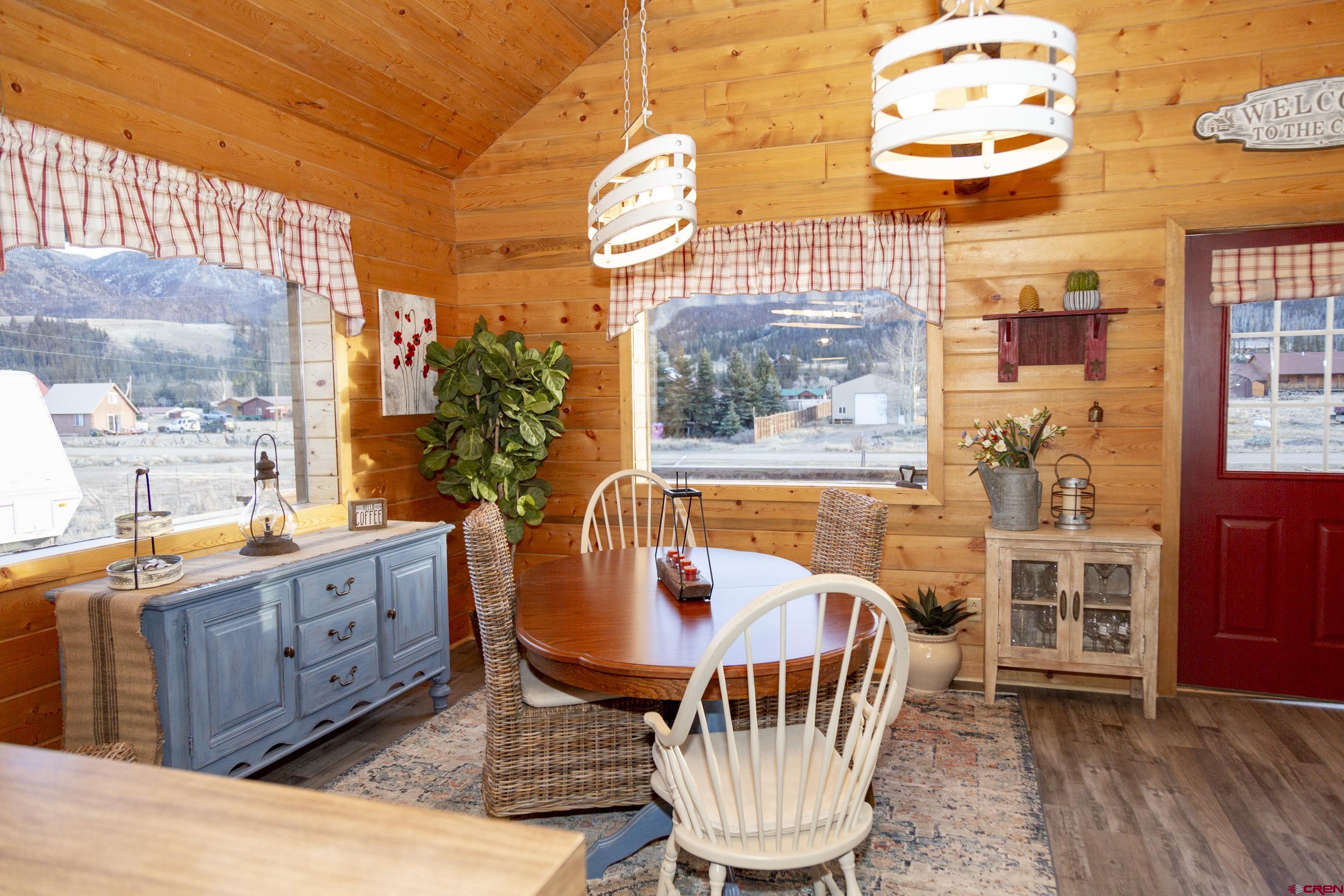 415 Ridge Drive Creede, CO 81130 - Photo 22 of 28 a dining room with furniture a rug and wooden floor