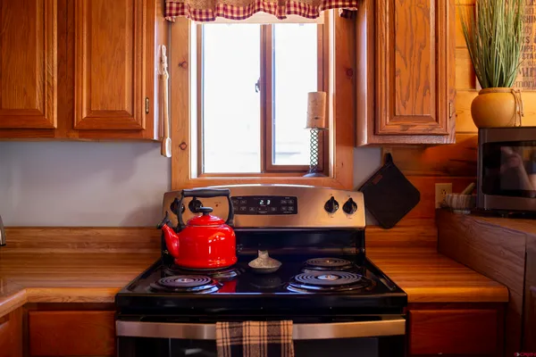 a stove top oven sitting inside of a kitchen