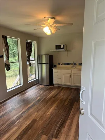a kitchen with a refrigerator and a stove
