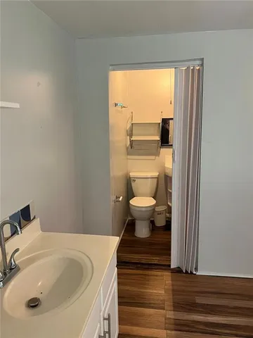 a bathroom with a sink a toilet and a window