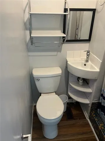 a bathroom with a toilet sink and mirror