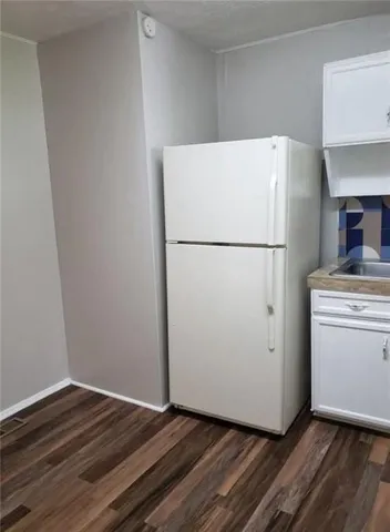 a white refrigerator freezer sitting in a kitchen