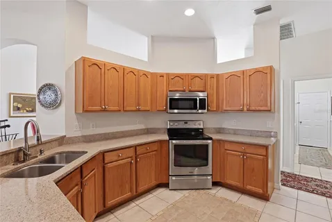 a kitchen with stainless steel appliances granite countertop a sink stove and microwave