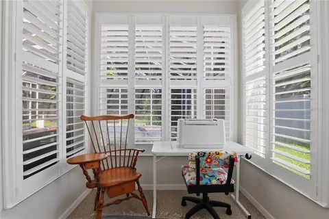 a balcony with couple of chairs and a chair